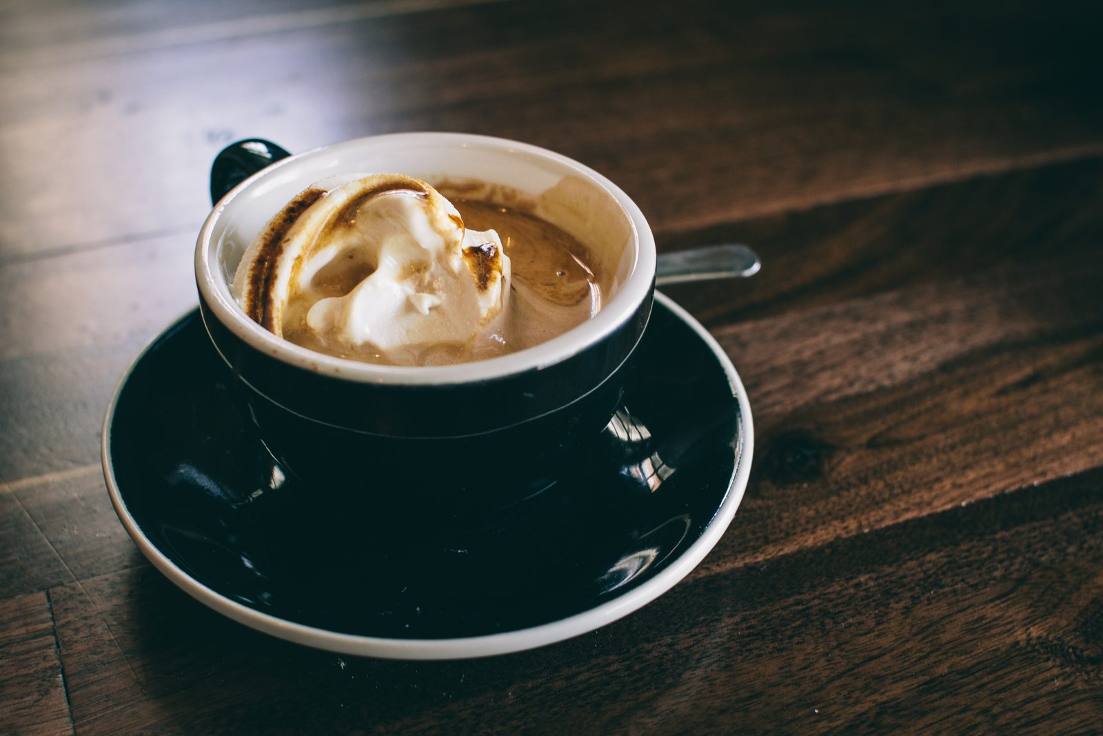 Cup of coffee on a dark wooden table